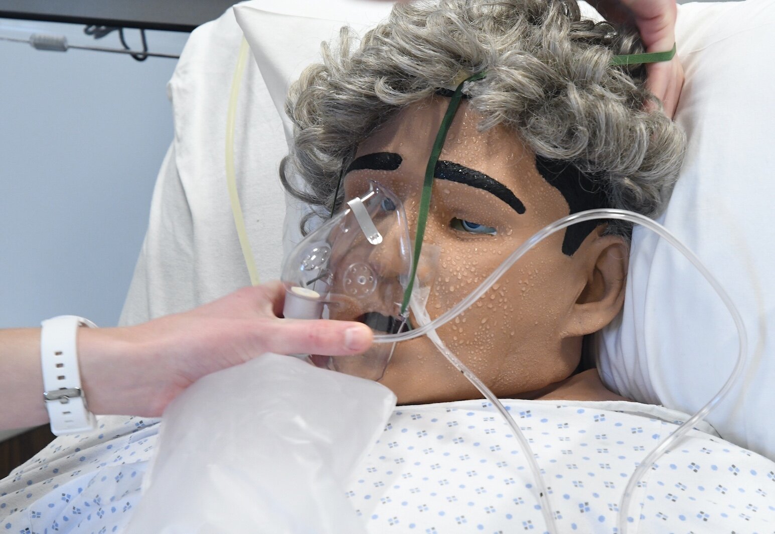 Caleb Vander Weide, a Kellogg Community College nursing student, adjusts the oxygen mask of a patient in the college’s sim lab.