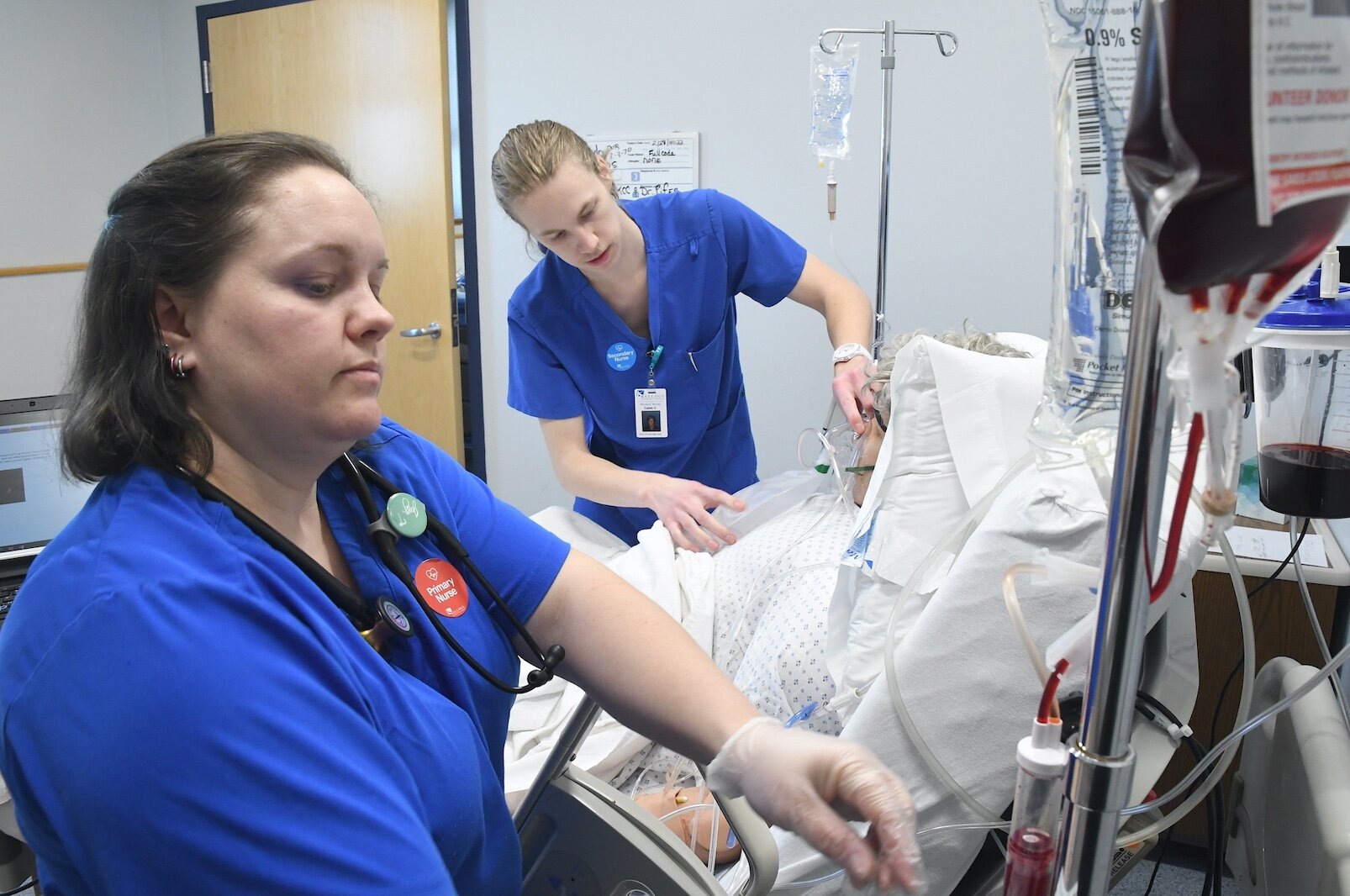 KCC nursing students, from left, Jenny Tice, and Caleb Vander Weide treat “patient” Amado Rojos in the college’s sim lab.