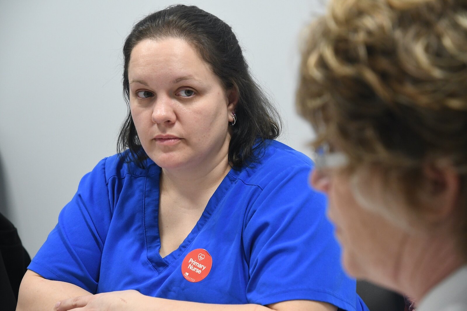 KCC nursing student Jenny Tice listens to Renee Mielke, Ed.D., KCC nursing professor, during a de- briefing session.