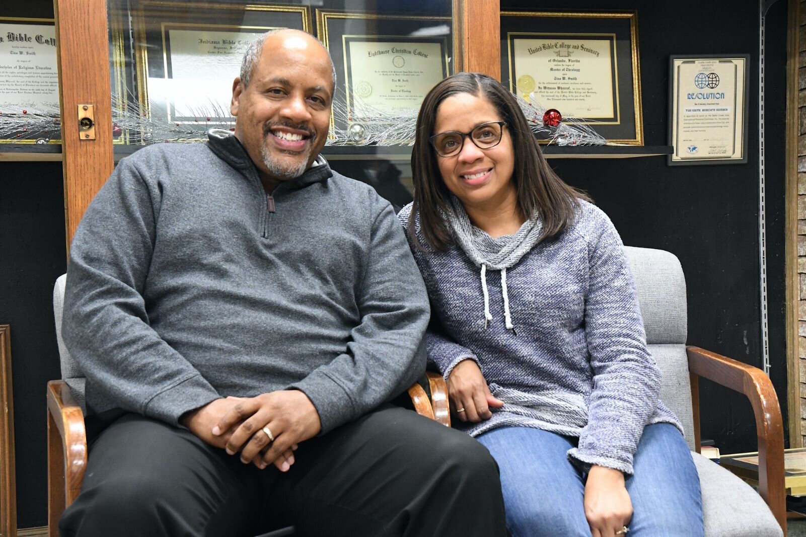 Dr. Tino and Nicole Smith sit in the hallway at Kingdom Builders Worldwide, which formerly housed Southeastern Middle School.