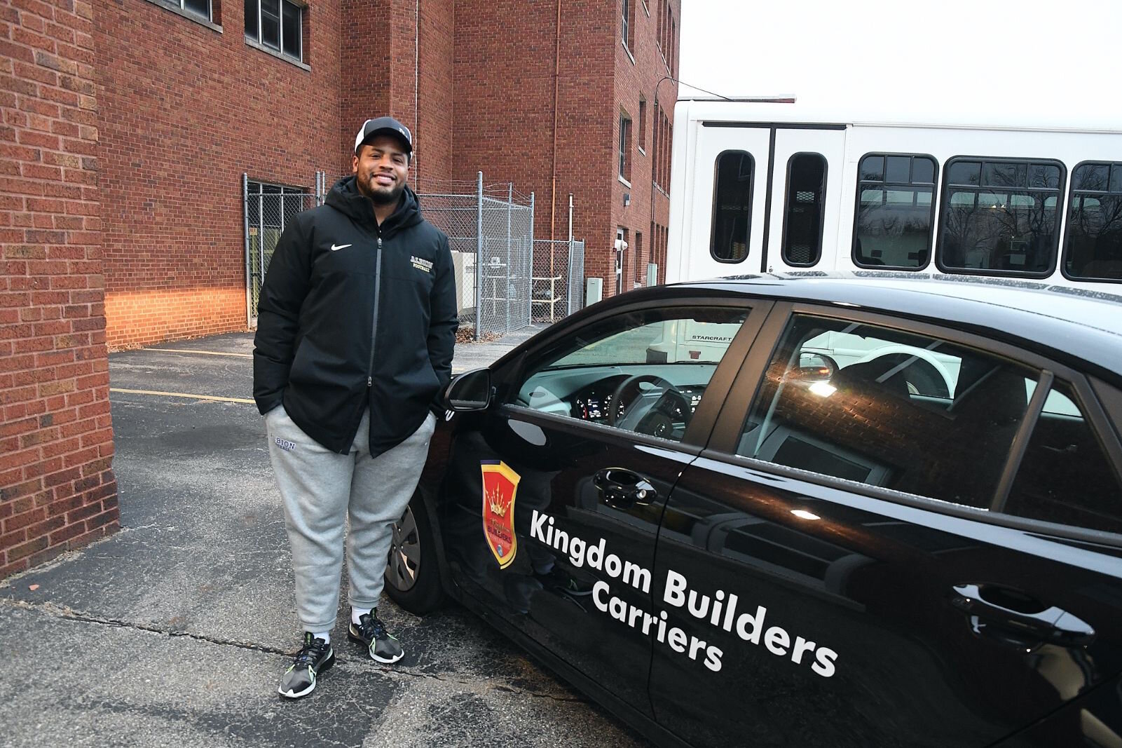 Tino Smith II stands by one of vehicles used by Kingdom Builders Worldwide.