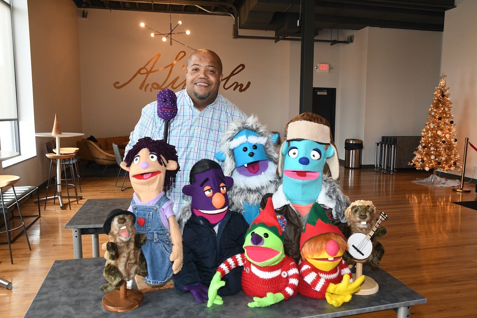 Clovis Bordeaux poses with an assortment of his puppets.