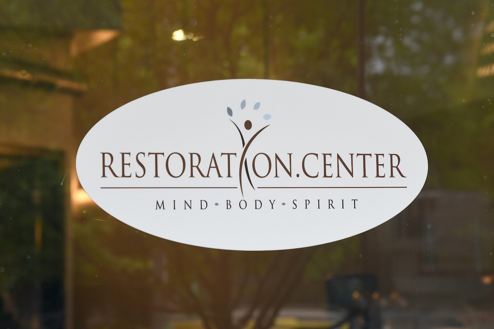 Signage of the front door of the Restoration Center.