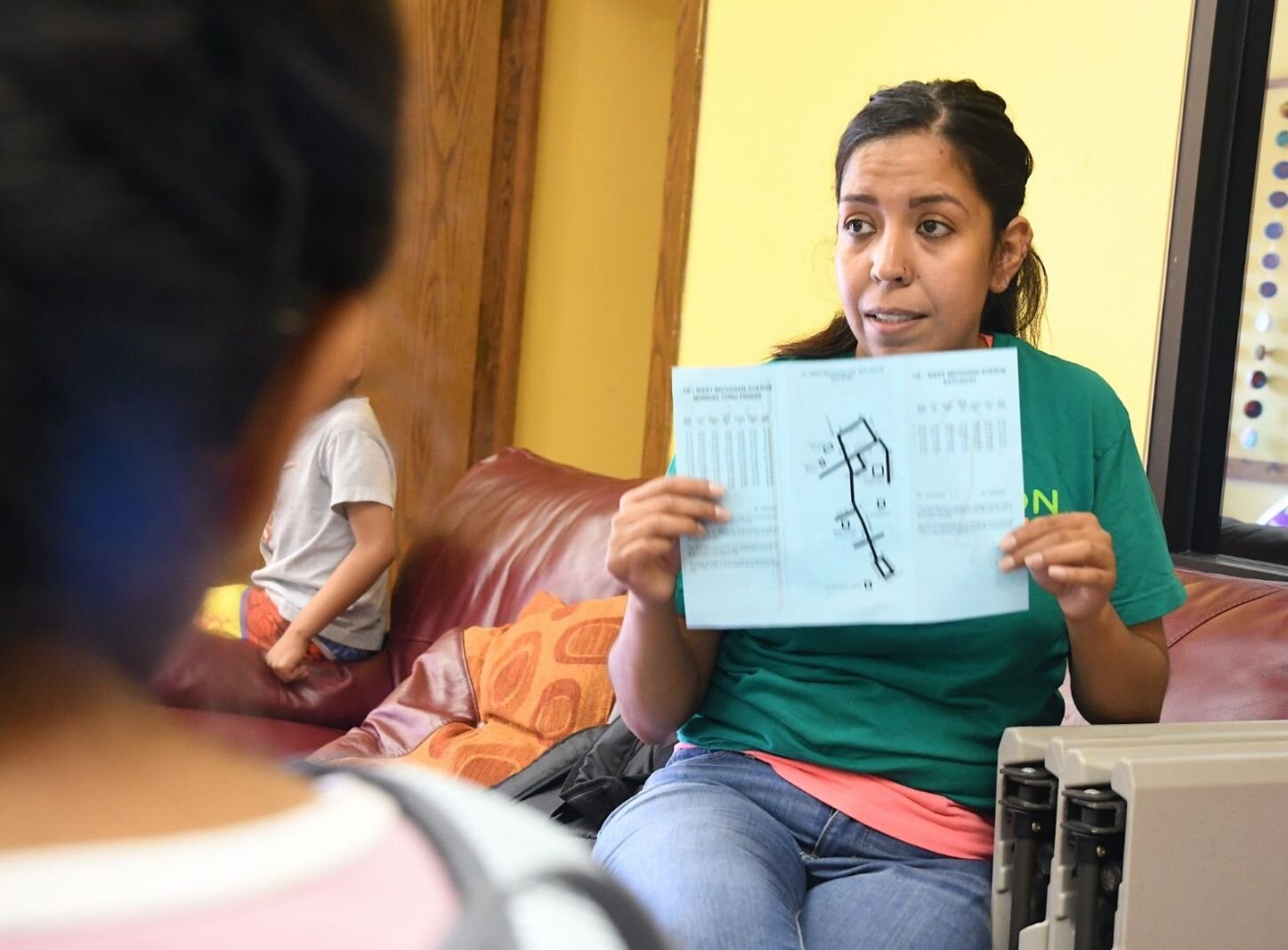 Evilia Bautista, VOCES program manager, explains to a group of children how to board and ride a Battle Creek city bus.