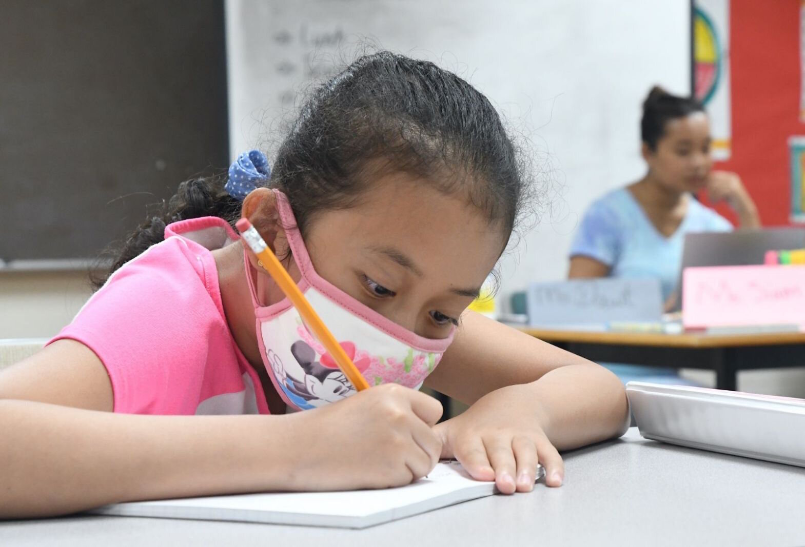 hian Mawi, 9, works on a project during a summer school session at the Burma Center.