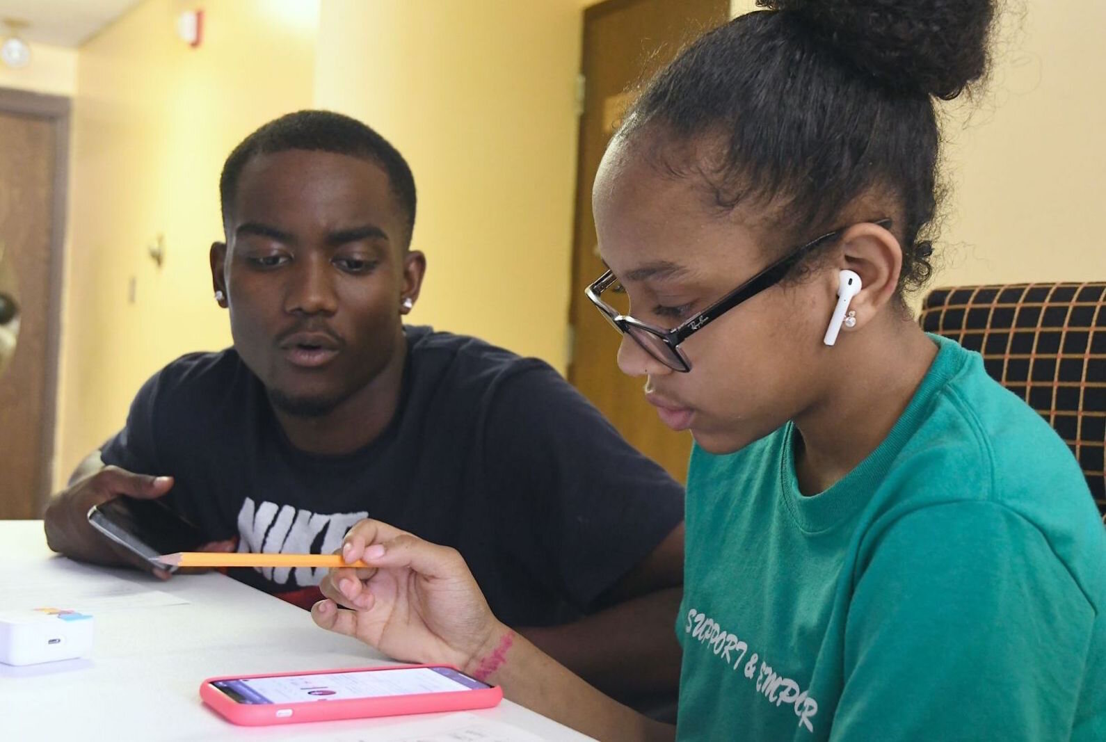 Parris Bolden, a student at Davenport University and a Battle Creek Central graduate, works with Riyana Palmer, 12, during RISE’s summer school program at Washington Heights United Methodist Church.