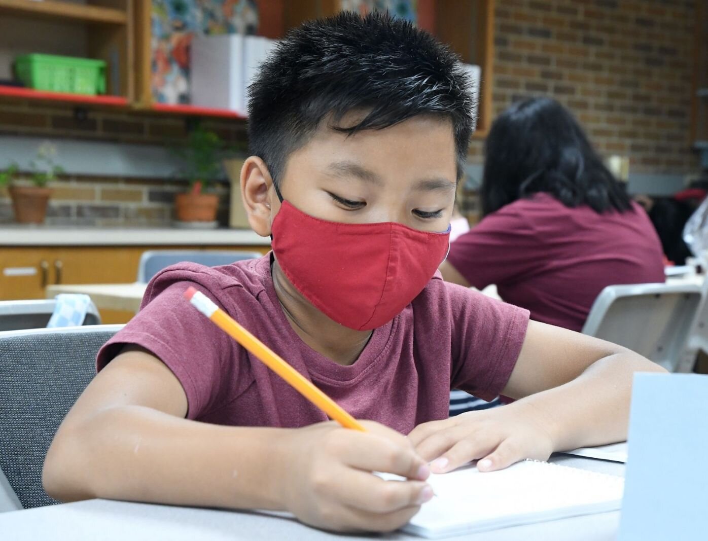 Joshua Bawi, 9, concentrates on a summer school session at the Burma Center.