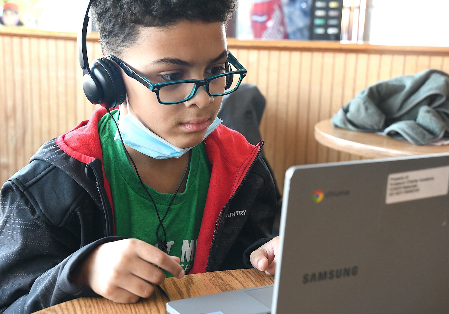 Landyn Warren, 8, a student at Endeavor Charter Academy watches a video at New Level’s after-school program Friday afternoon.