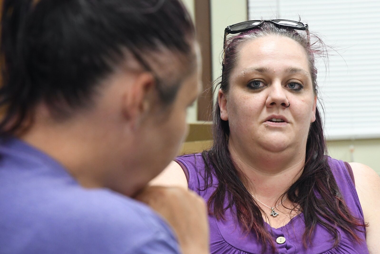 Lacey Kequom, right, Case Manager at the SHARE Center, talks with Nikki, 42.