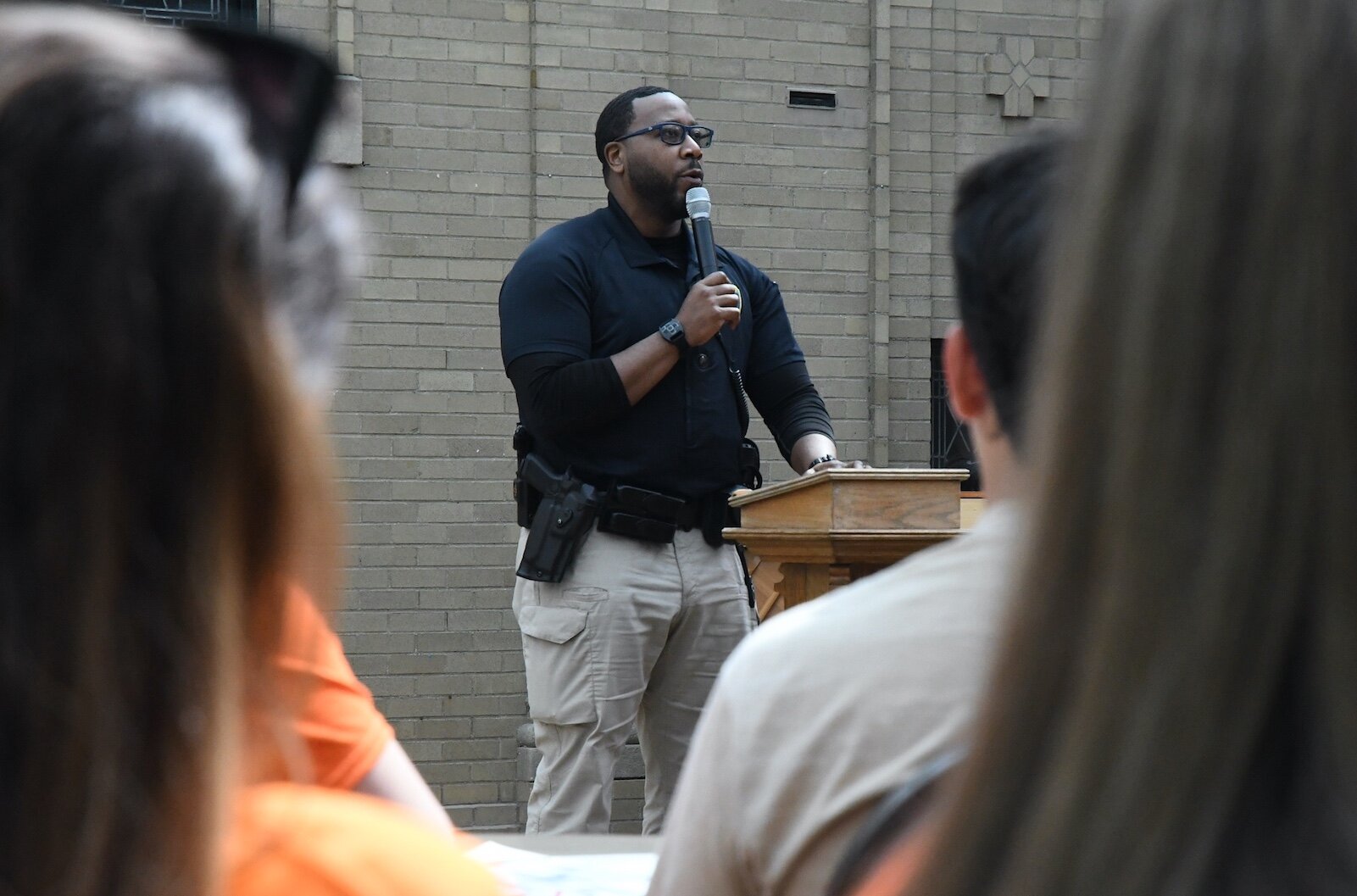 Battle Creek Police Offficer Deandre Perry, a liaison officer at Battle Creek Central High, speaks during an anti-gun violence rally at First Congregational church in downtown Battle Creek.