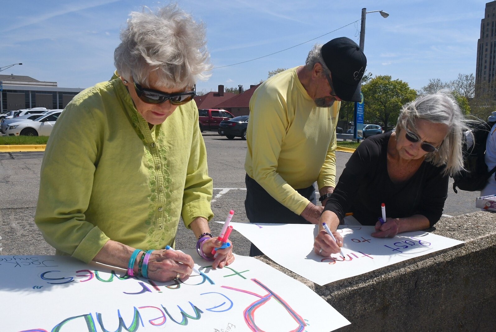 Preparing signs prior to an anti-gun violence march and rally in downtown Battle Creek are from left, Sue Keitel, Rich and Sue Heeres.