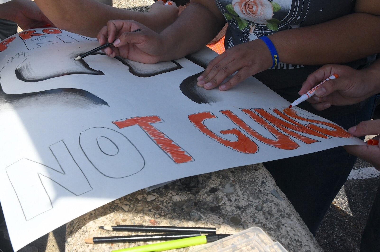 People prepare signs before an organizer of an anti-gun violence march and rally in downtown Battle Creek.