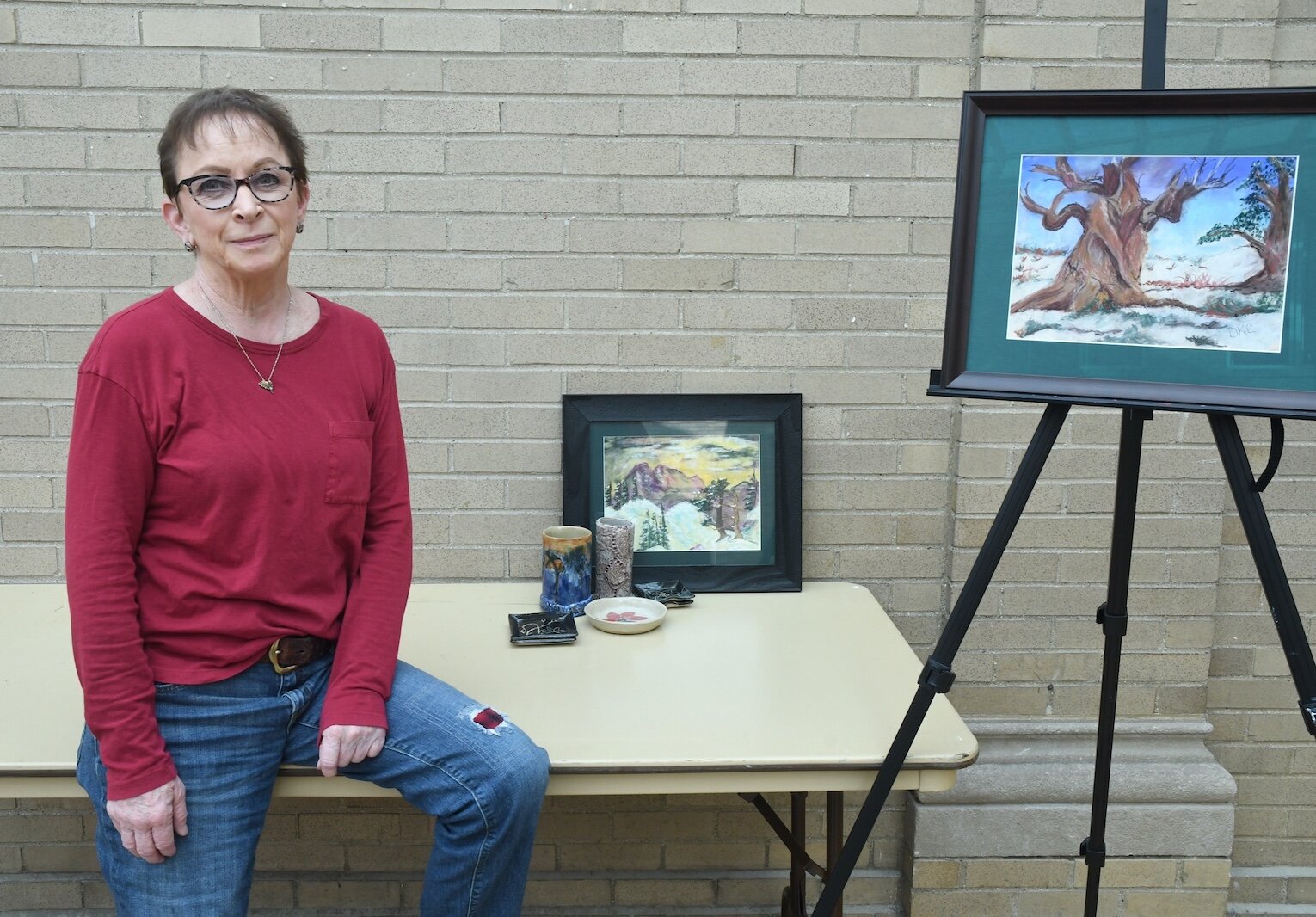 Kristen Carlton is seen with some of her paintings in pottery.