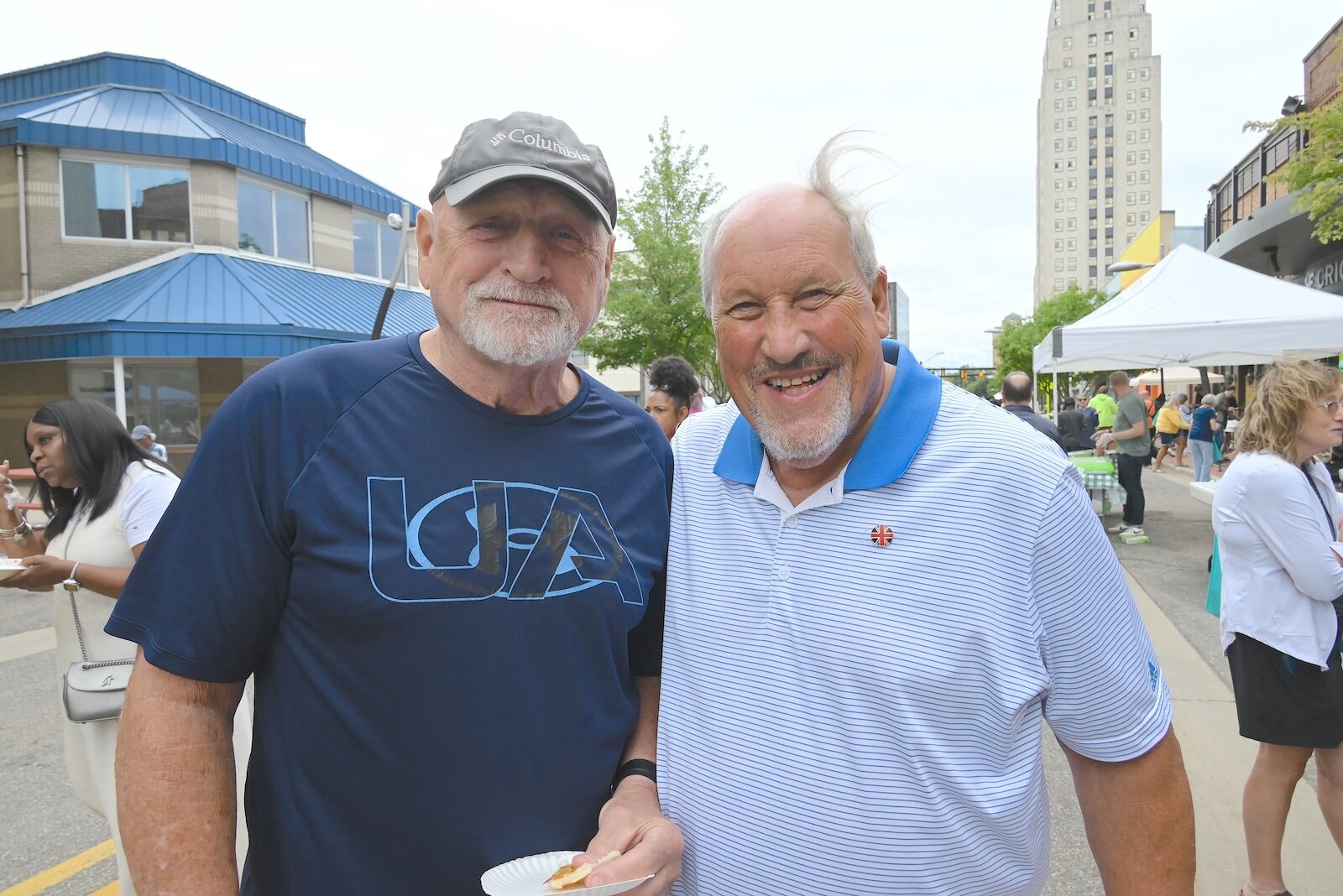 Former downtown Battle Creek Police Department beat cop Mike St. John, left, and community leader Chuck Adams are seen at the BCCF’s block party.