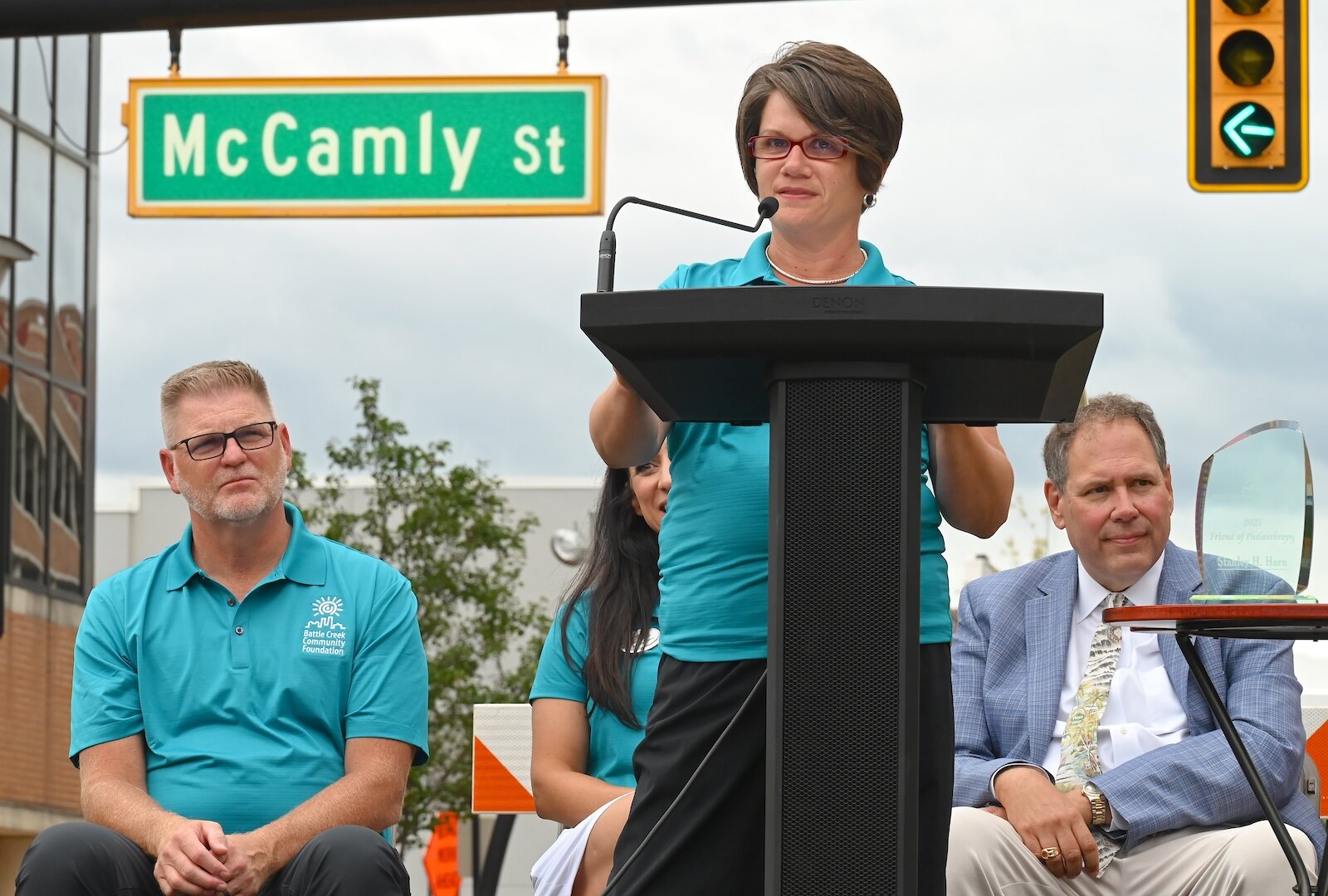 Mary Muliett, President and CEO of the Battle Creek Community Foundation addresses those in attendance at the block party. BCCF Board President Rob Ridgeway is seen to the left in the photo.