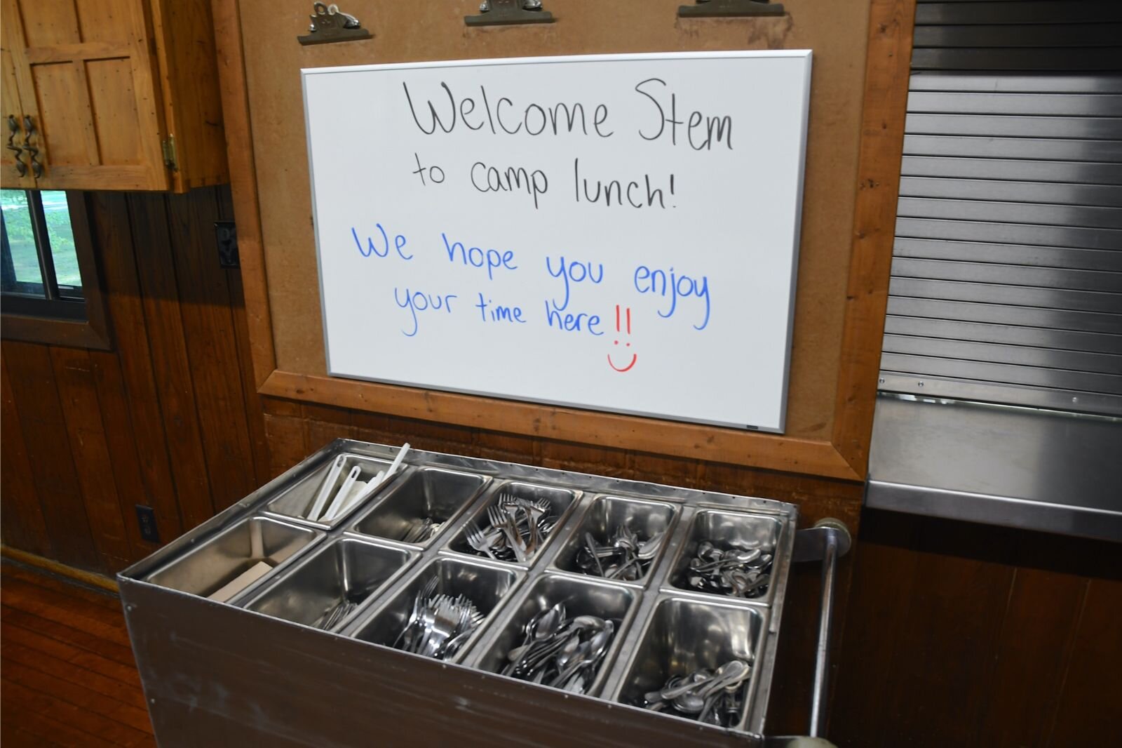 Eating utensils and a welcome sign in the dining area at Clear Lake Camp