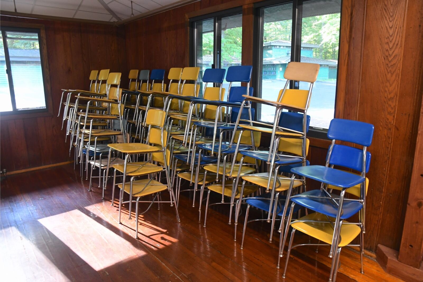 Chairs in the colors of Battle Creek Public Schools sit in a corner of the dining area of Clear Lake Camp.