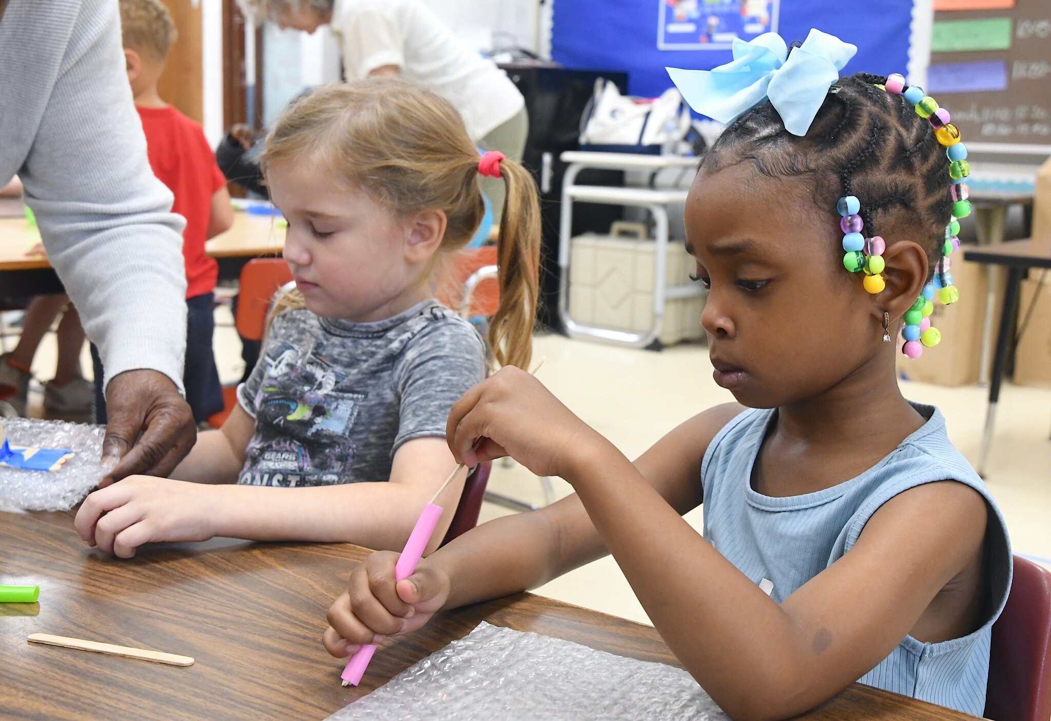 Ziva Jo Swafford, left, Ayla Lesley workin on building their boats during a morning session at Franklin-Post Elementary School.