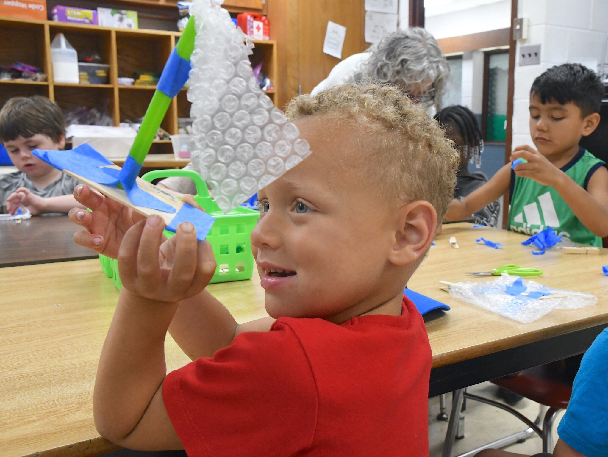 Sky Edwards, left, Jayden Brown, center, and, Ayden Martinez, right, are seen with their boats during a morning session at Franklin-Post Elementary School.