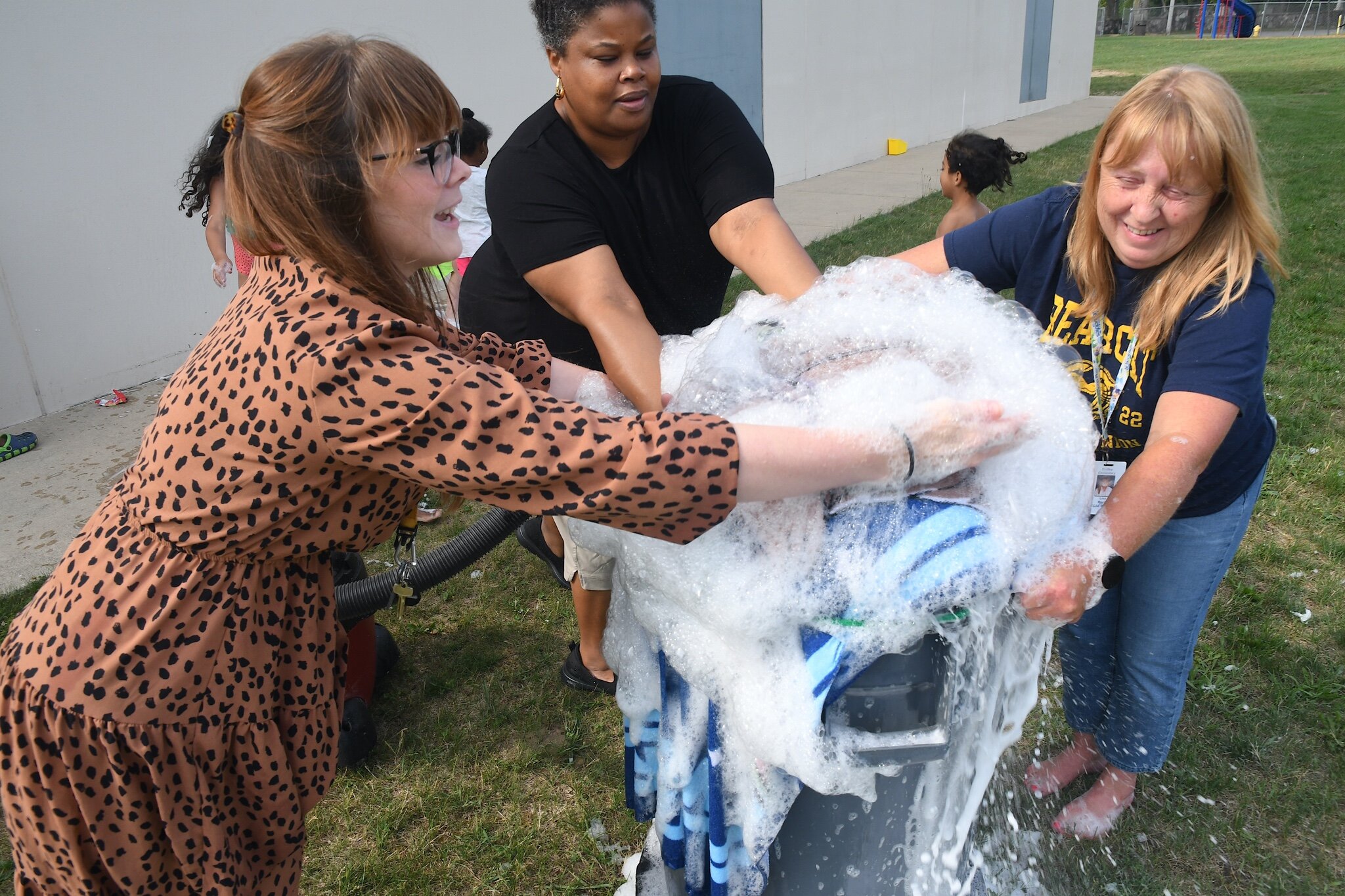 Tricha Grajek, left, SaRah Williams, center, and Lisa Merry, right make bubbles during a morning session at Franklin-Post Elementary School.
