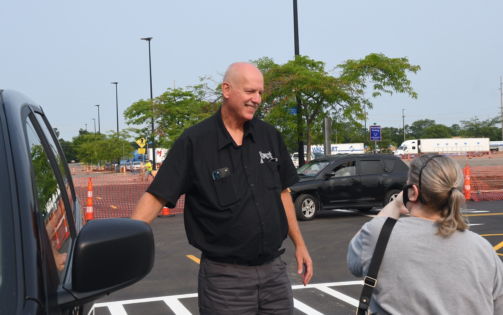 Brian Scott of BC Transit talks with a customer after taking her to work.