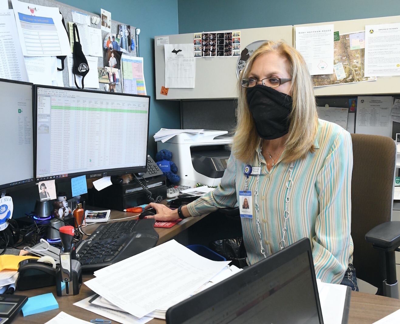 Melinda Weaver, Calhoun County’s Deputy Treasurer, talks with colleagues in the office about property foreclosures.