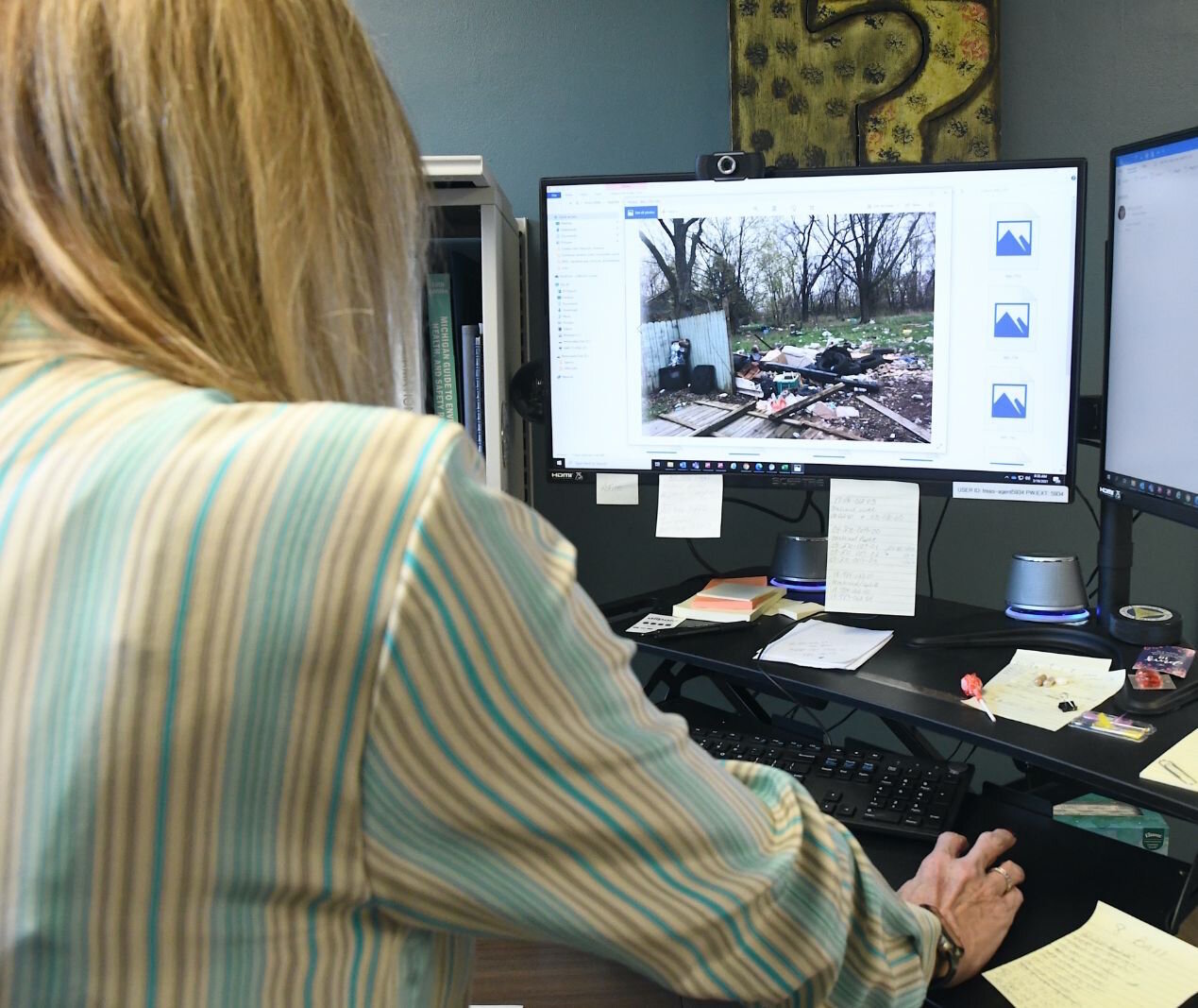 Melinda Weaver, Calhoun County’s Deputy Treasurer, looks a photo of property in Albion that will be foreclosed upon.