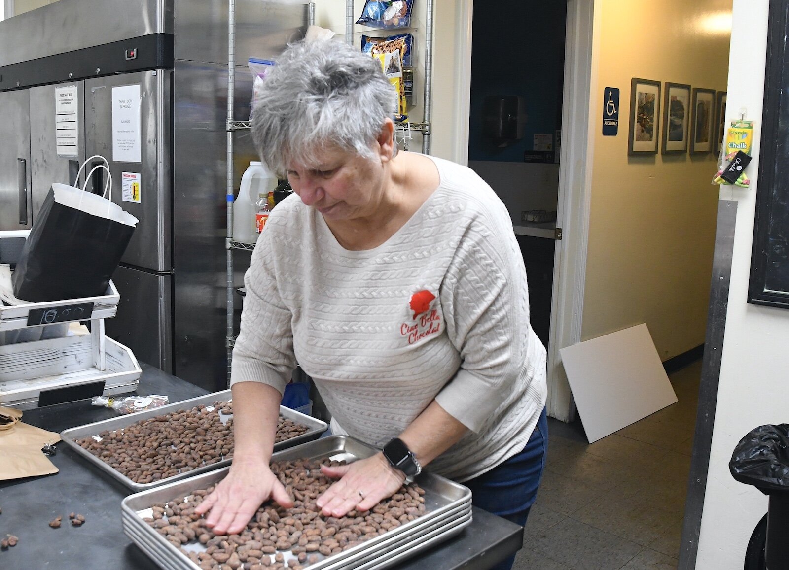 Karen Pacella sorts through raw cacao beans prior to roasting.