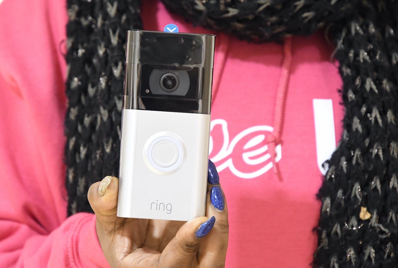 Nakisha Newton holds a Ring smart doorbell.