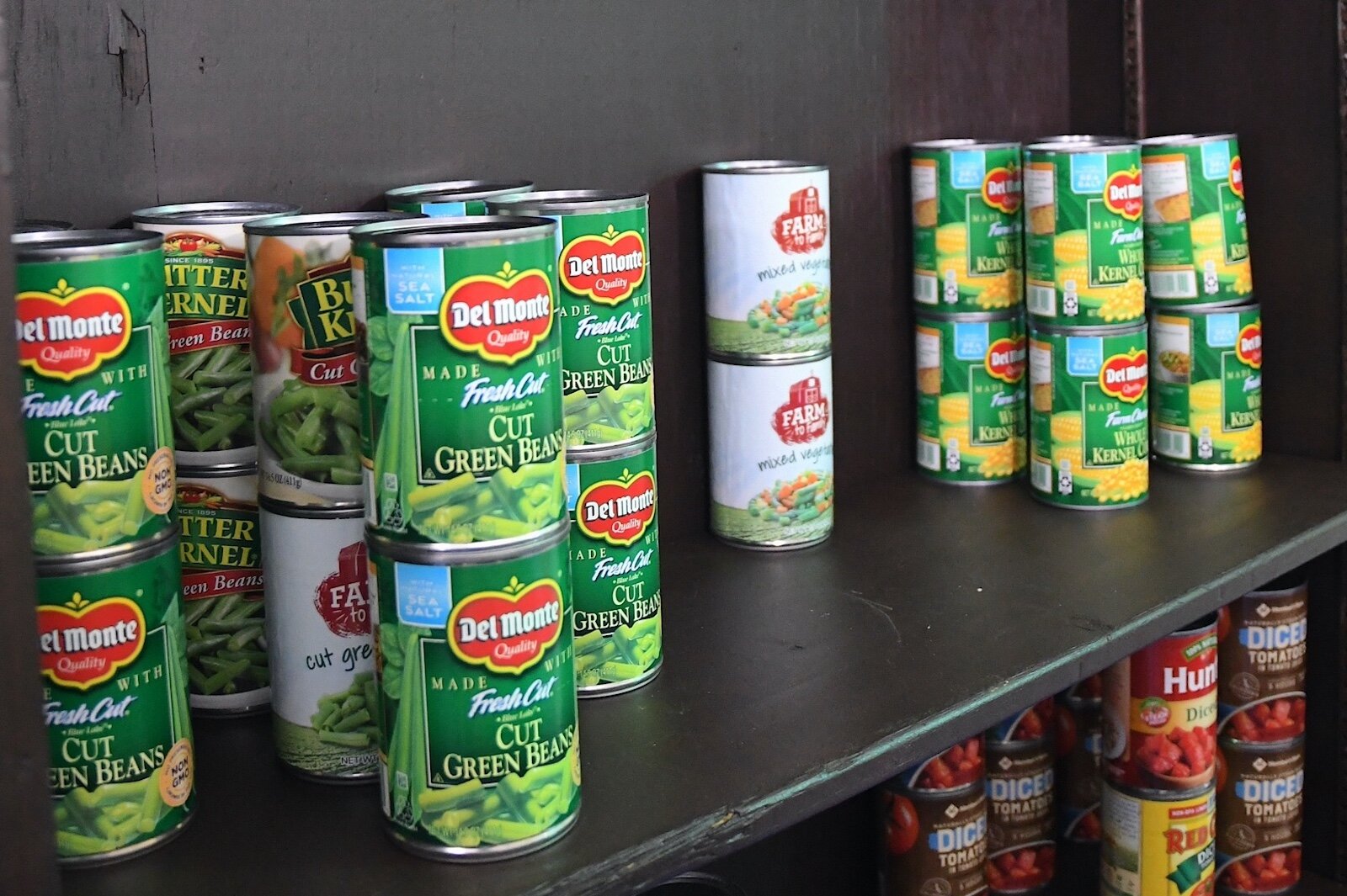 Cans of vegetables are on shelves in the food pantry of Faith Temple Church of God in Christ.