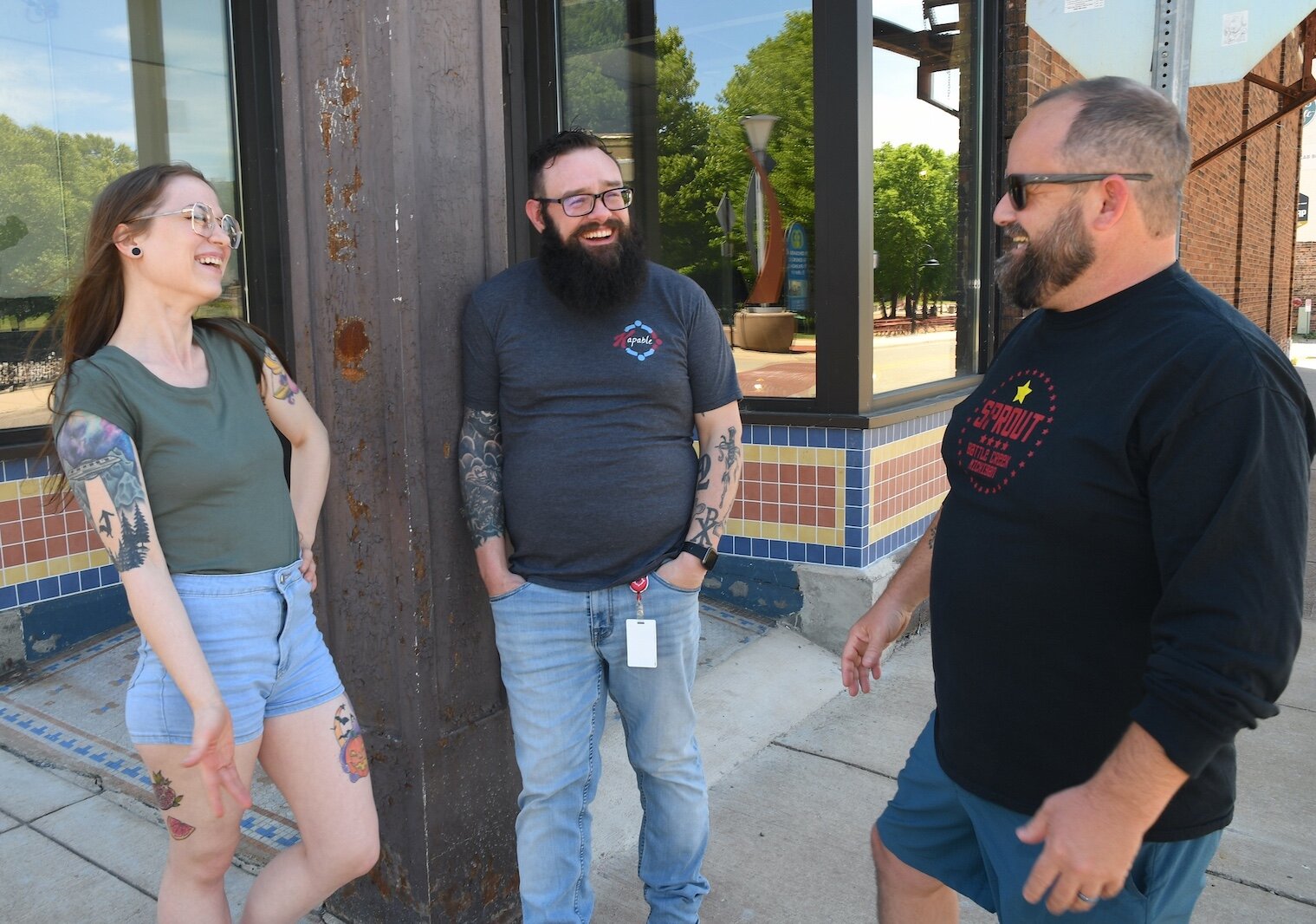 Talking informally in front of the future location a local food co-op in downtown Battle Creek are, from left, Rachel Ostrander, Jared Kirtley, and Jeremy Andrews.