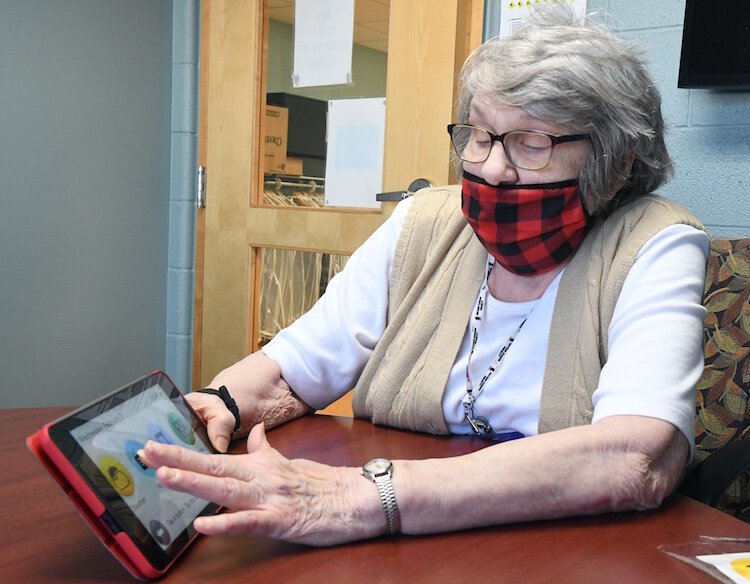 Jerilyn Finn-Cummings demonstrates the ease of use of her GrandPad.