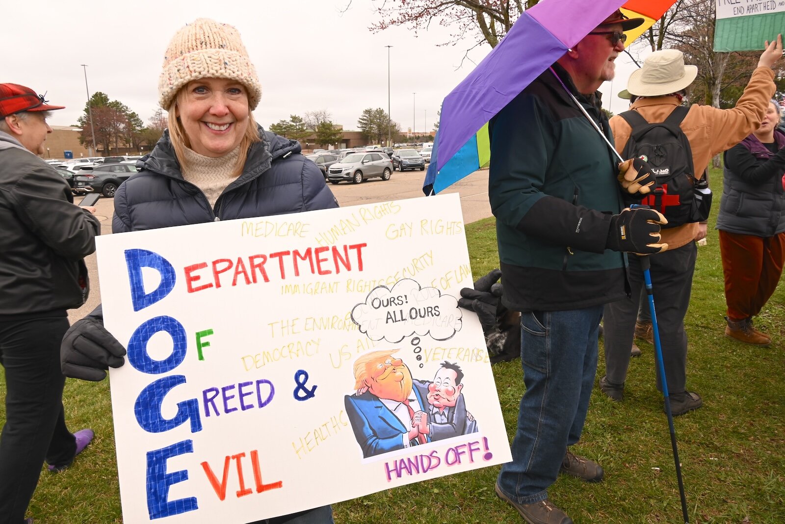Katie Reasons holds a sign at the April 5 Hands Off demonstration on Beckley Road in Battle Creek.