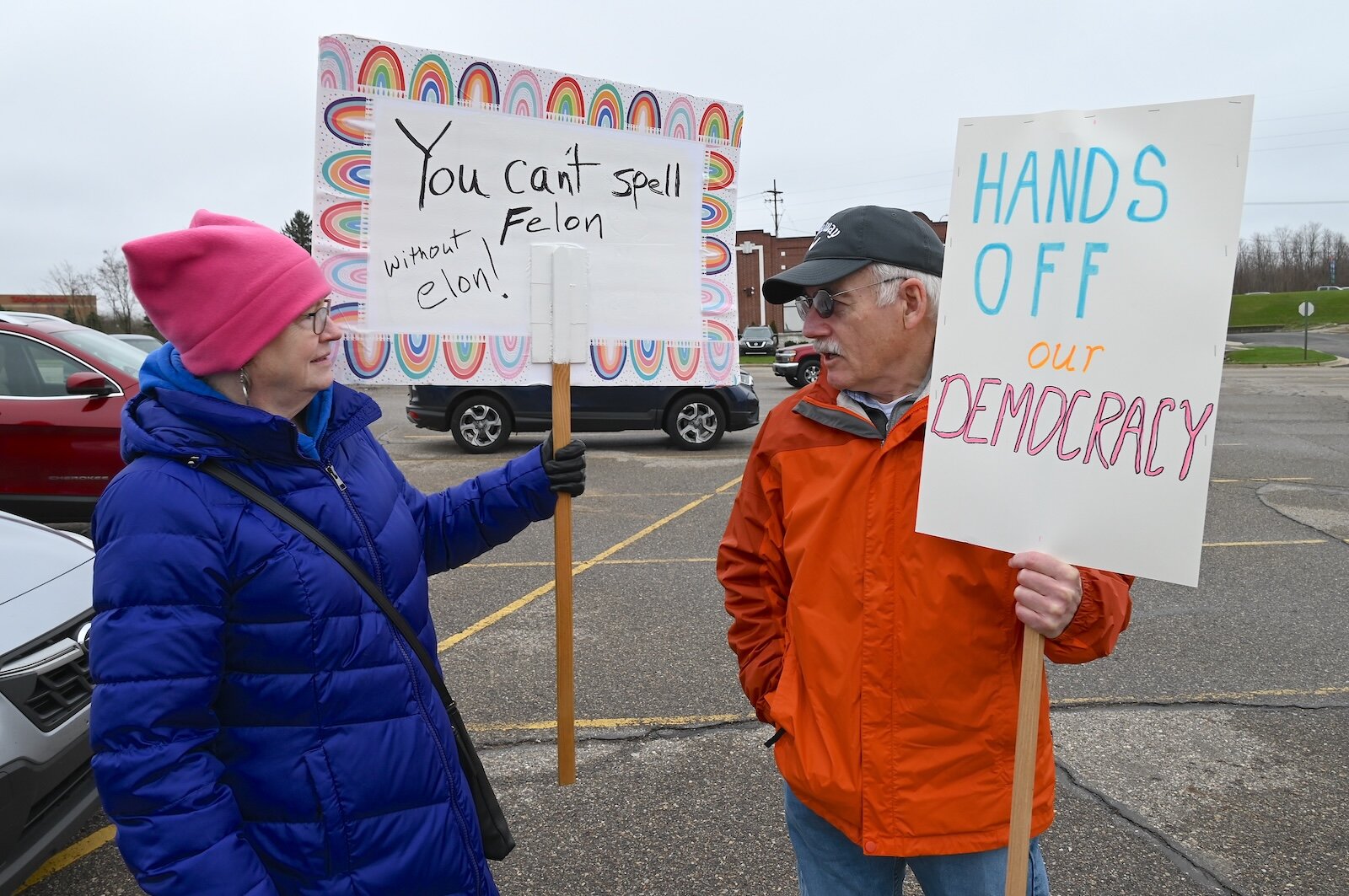  Colleen LaRose, left, and Al Lake hold signs as they prepare to attend the April 5 Hands Off demonstration on Beckley Road in Battle Creek.