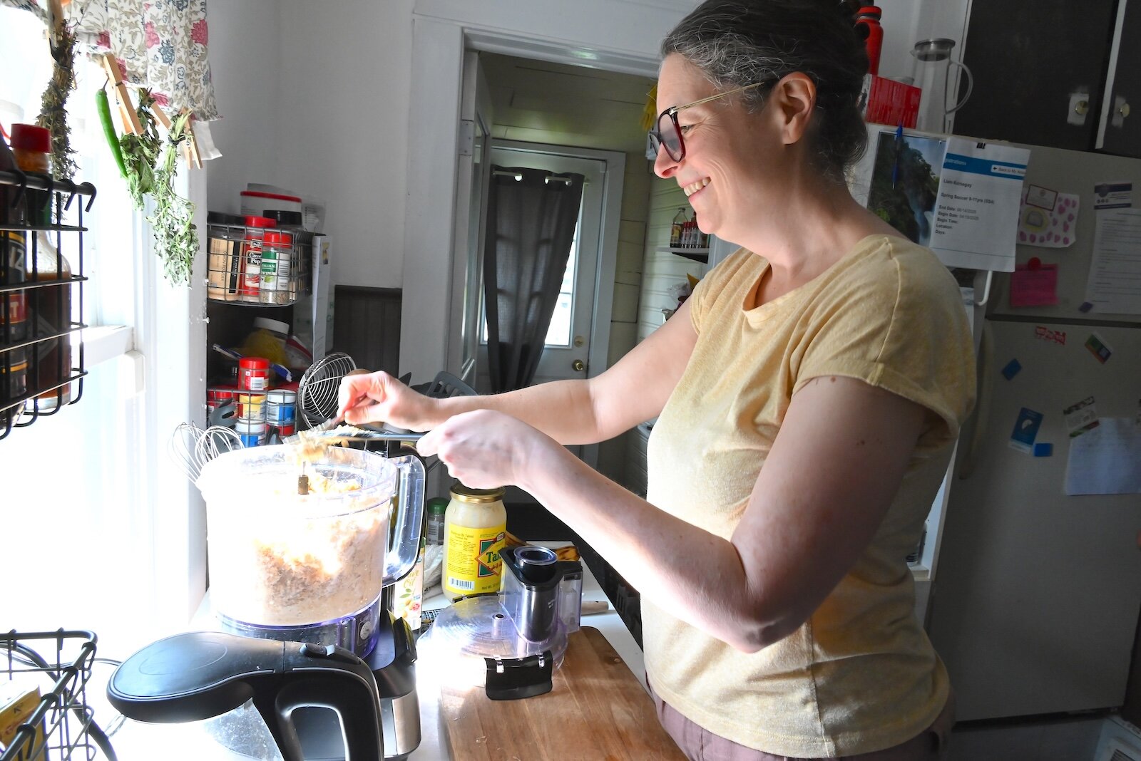 Stacey Kornegay stirs homemade hummus in her kitchen.