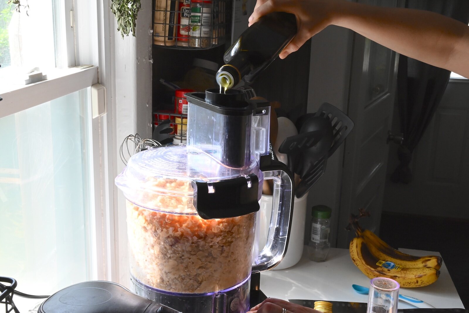 Stacey Kornegay adds olive oil to the hummus she is making.
