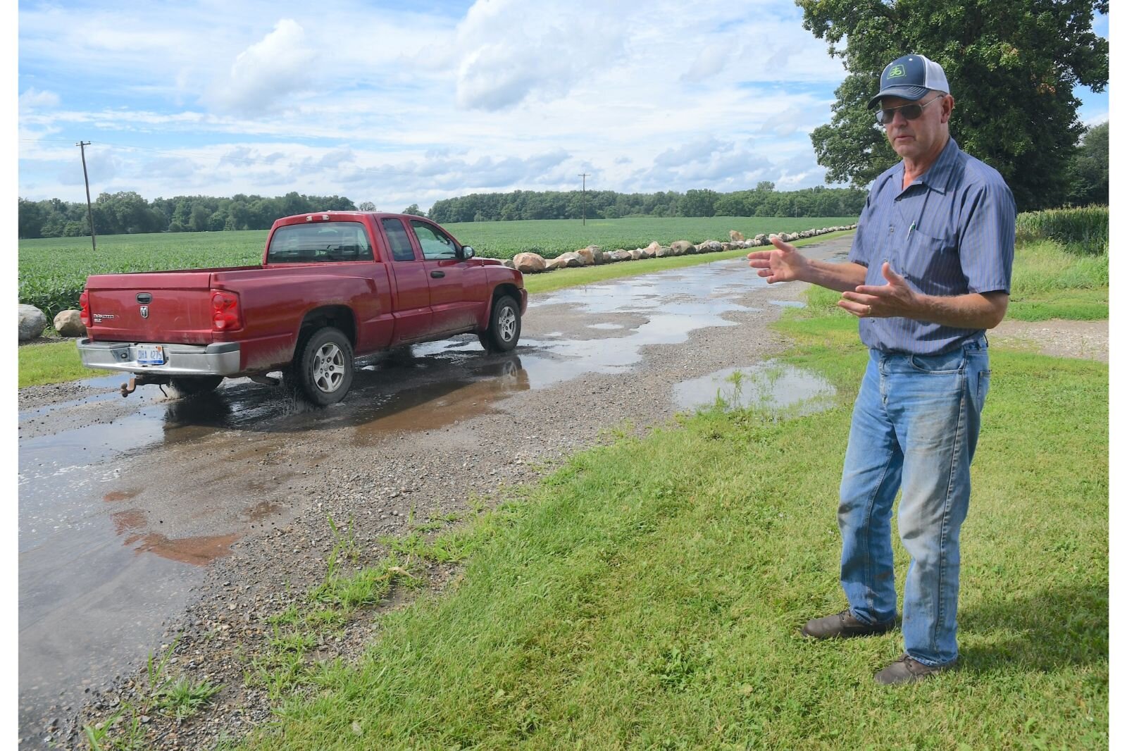 Fred Heaton stands along 24 Mile Road in Clarendon Township and talks about the poor quality of the roads in this part of Calhoun County.