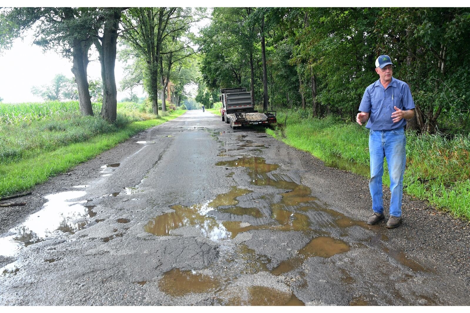 Fred Heaton standing along R Drive South has offered to help pay to repair some of the roads in Calhoun County.