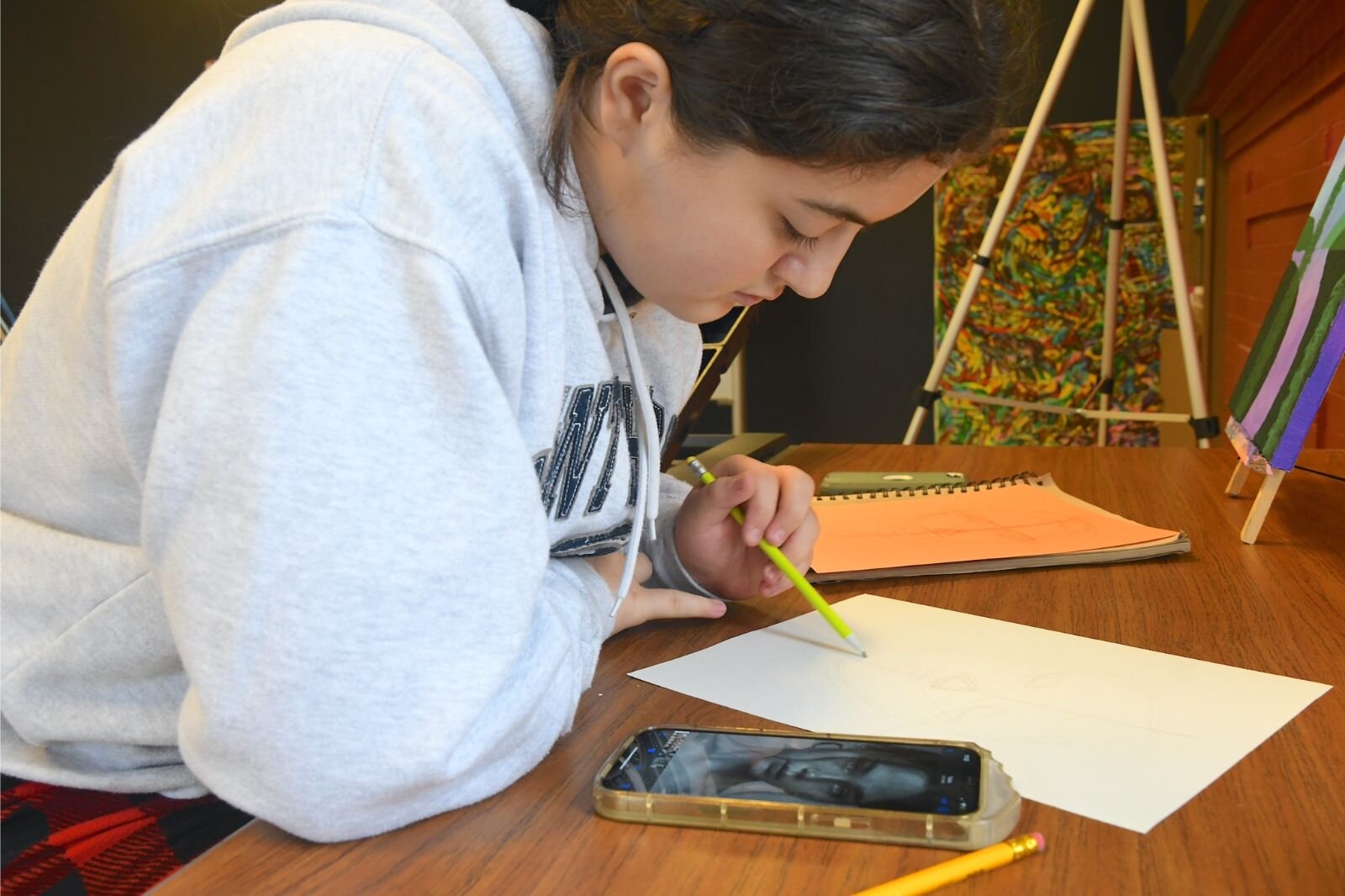 Willow Schantz works on a portrait.