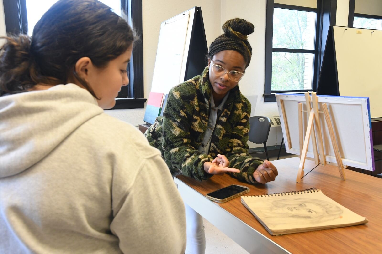 Jamari Taylor, right, provides feedback to one of her students, Willow Schantz.