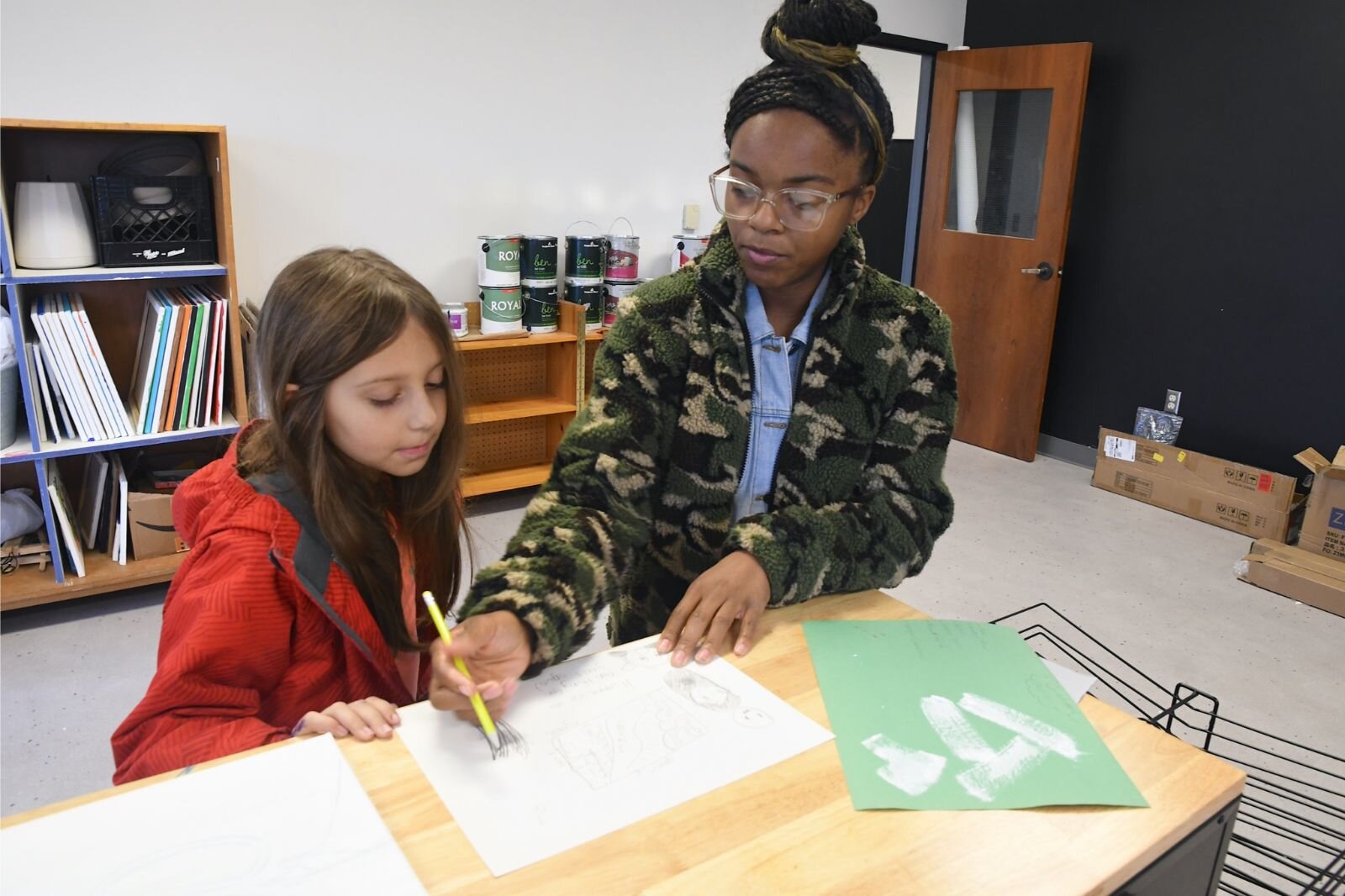 Jamari Taylor, right, works with one of her students, Cora Vance.