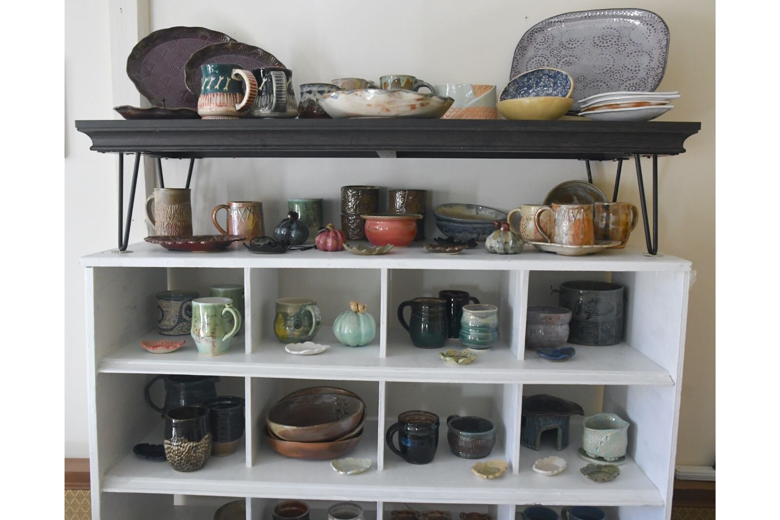 A shelf in Laura’s work area holds a variety of her creations.