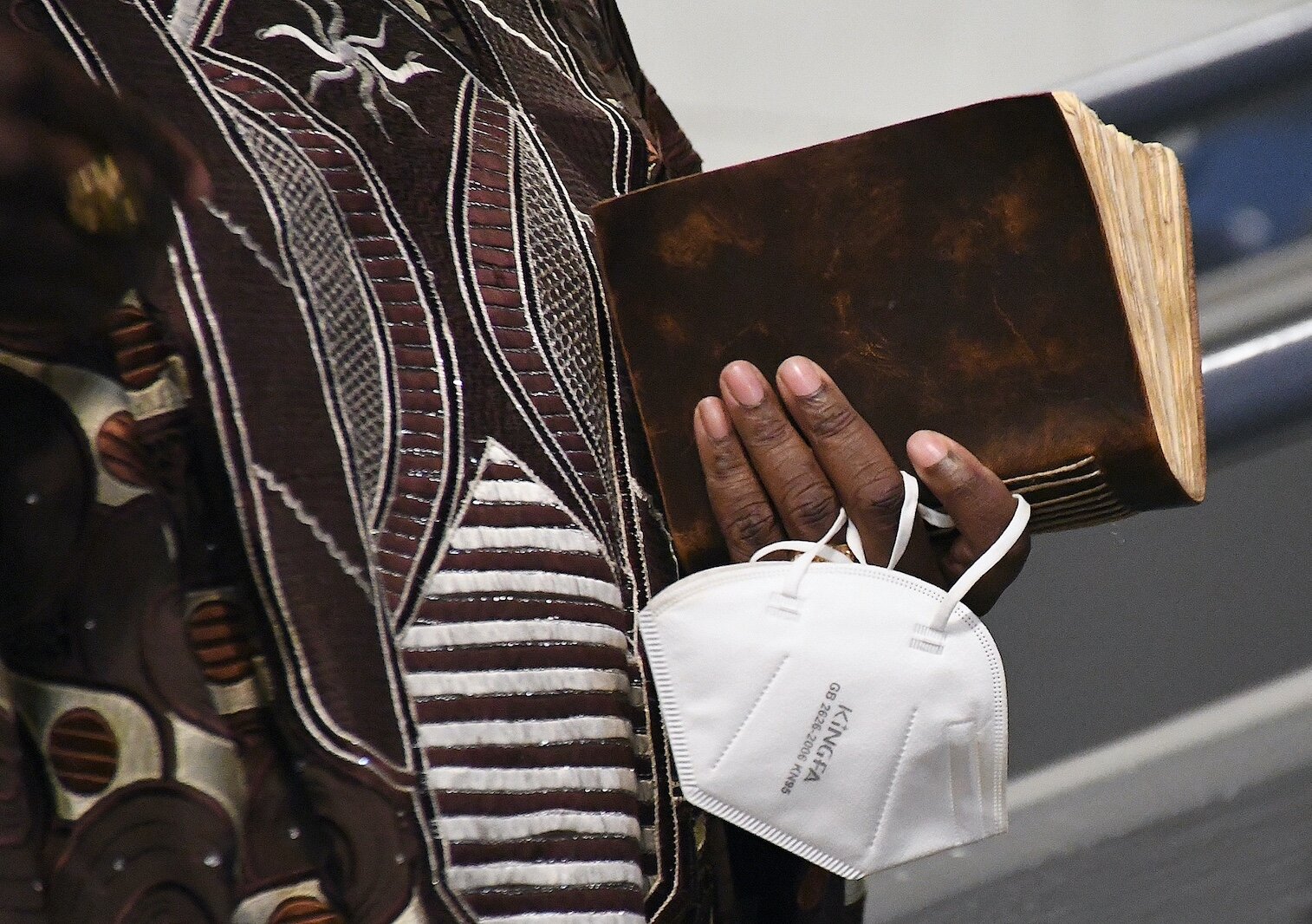 Dr. L.E. Johnson holds mask and a book at Monday’s “We, Us, Our: 55 Shades of Black” commemoration of Martin Luther King, Jr’s birthday.