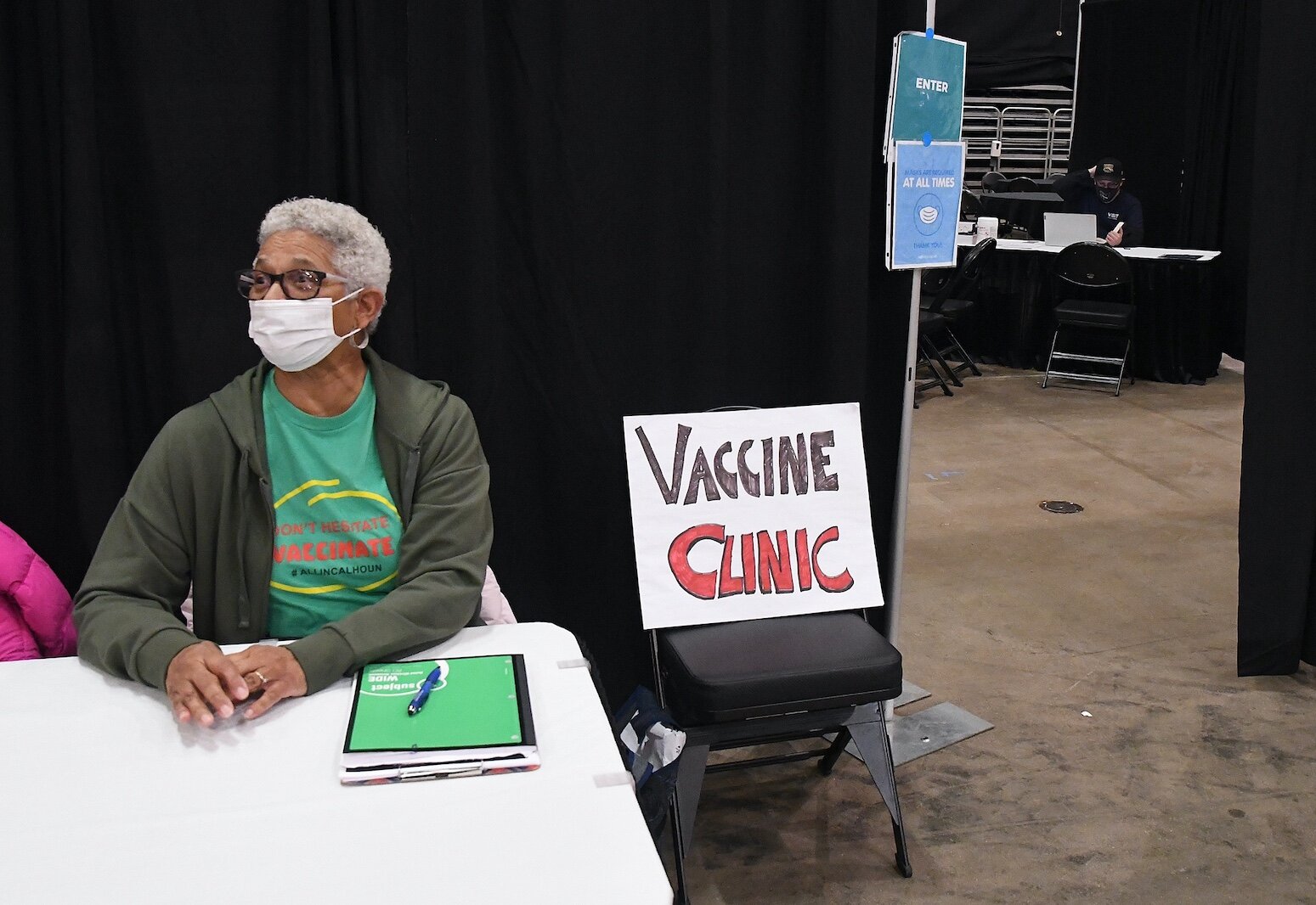 Yvonne Townsend, a COVID vaccine ambassador, waits to greet people outside the vaccine clinic organized by Battle Creek Truth, Racial Healing, and Transformation at Monday’s “We, Us, Our: 55 Shades of Black” commemoration of Martin Luther King, Jr’s 