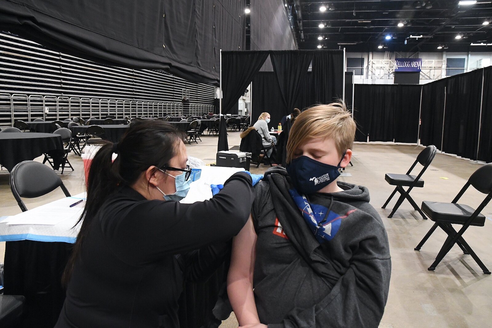 George Pyatt, 13, receives Pfizer COVID vaccine booster at a vaccine clinic organized by Battle Creek Truth, Racial Healing, and Transformation during Monday’s “We, Us, Our: 55 Shades of Black” commemoration of Martin Luther King, Jr’s birthday spons