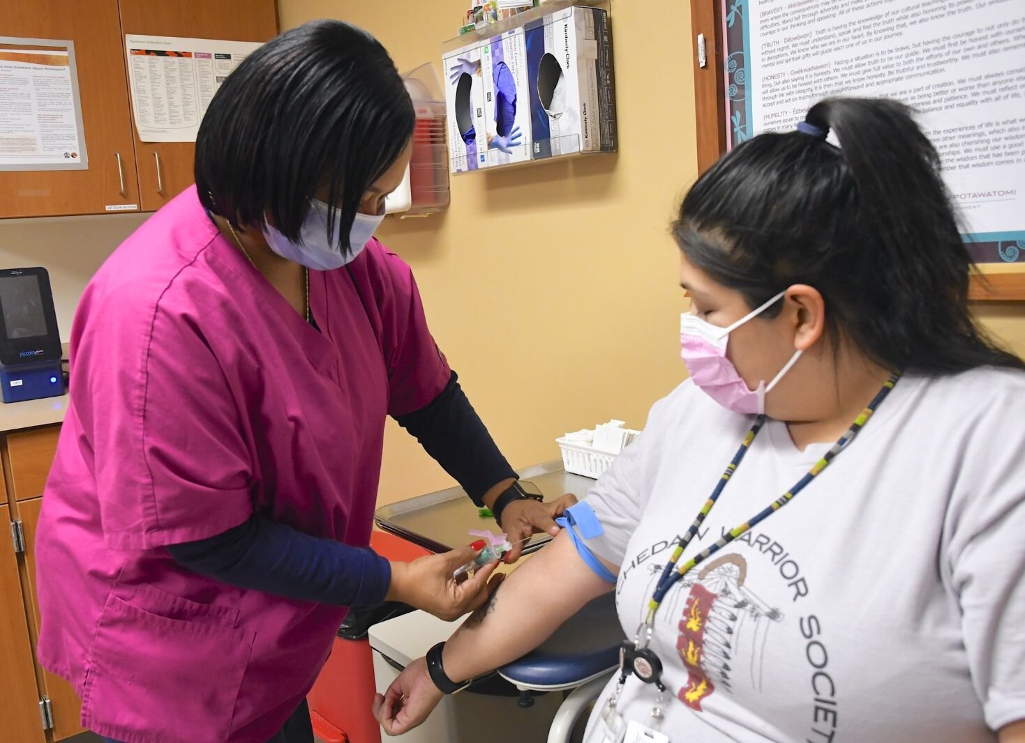 Laura Marshall, Medical Assistant, demonstrates a blood draw with Melinda Hostiguin.