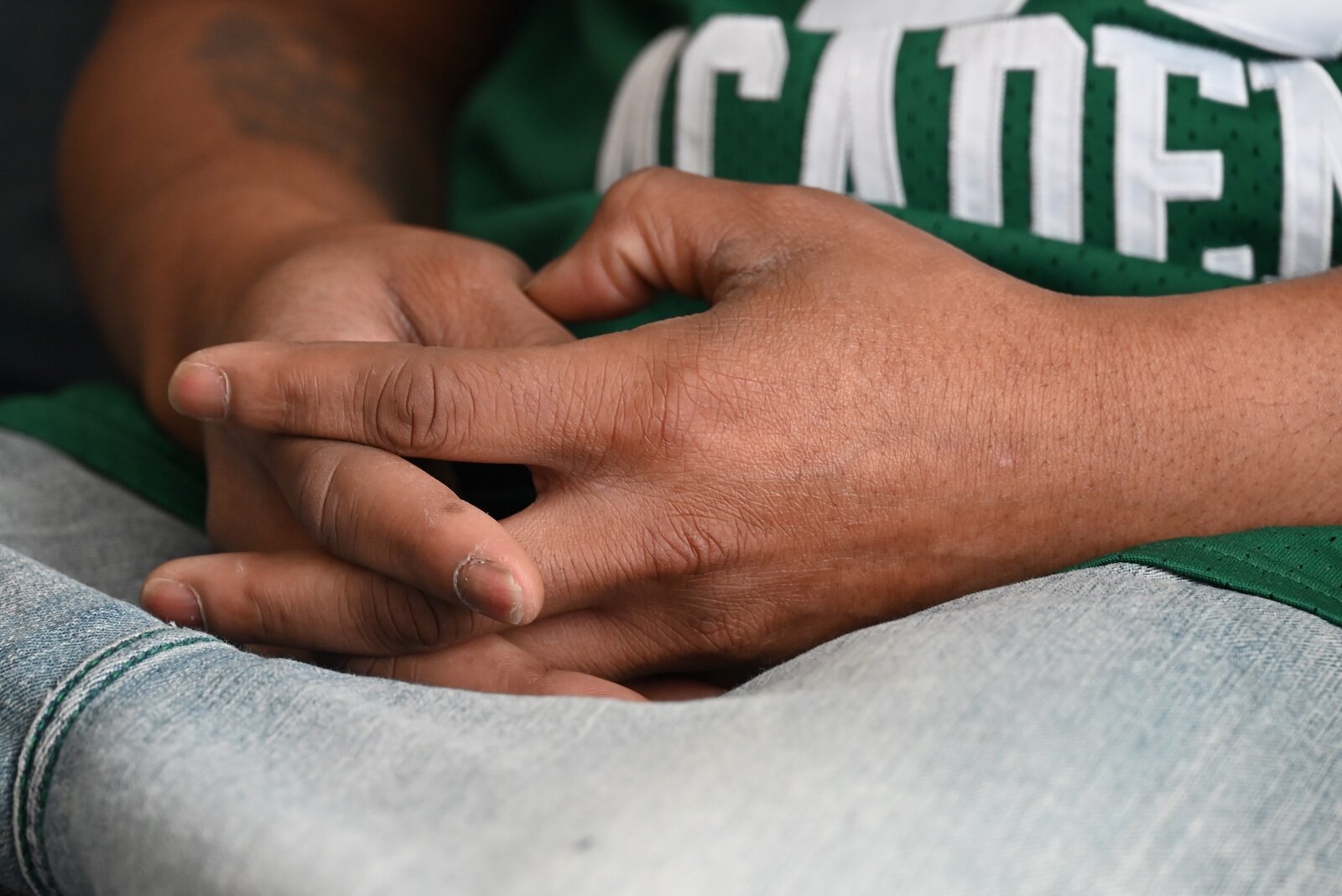 Quinton Bozell reflects on his life while sitting on a sofa in his apartment.