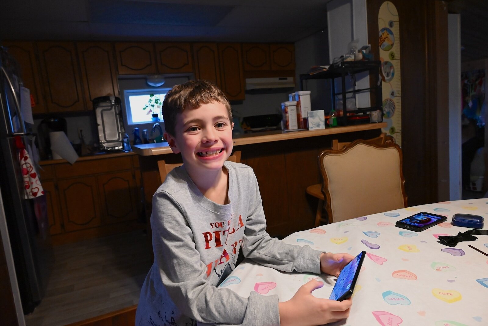 Skyler Ramos pauses while playing a video game at his family’s home in Marshall.