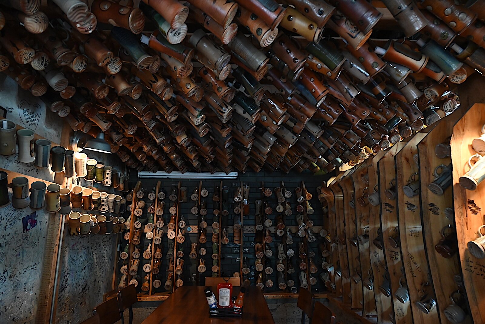 Scenes inside Dark Horse’s tap room feature some of the hundreds of mugs.