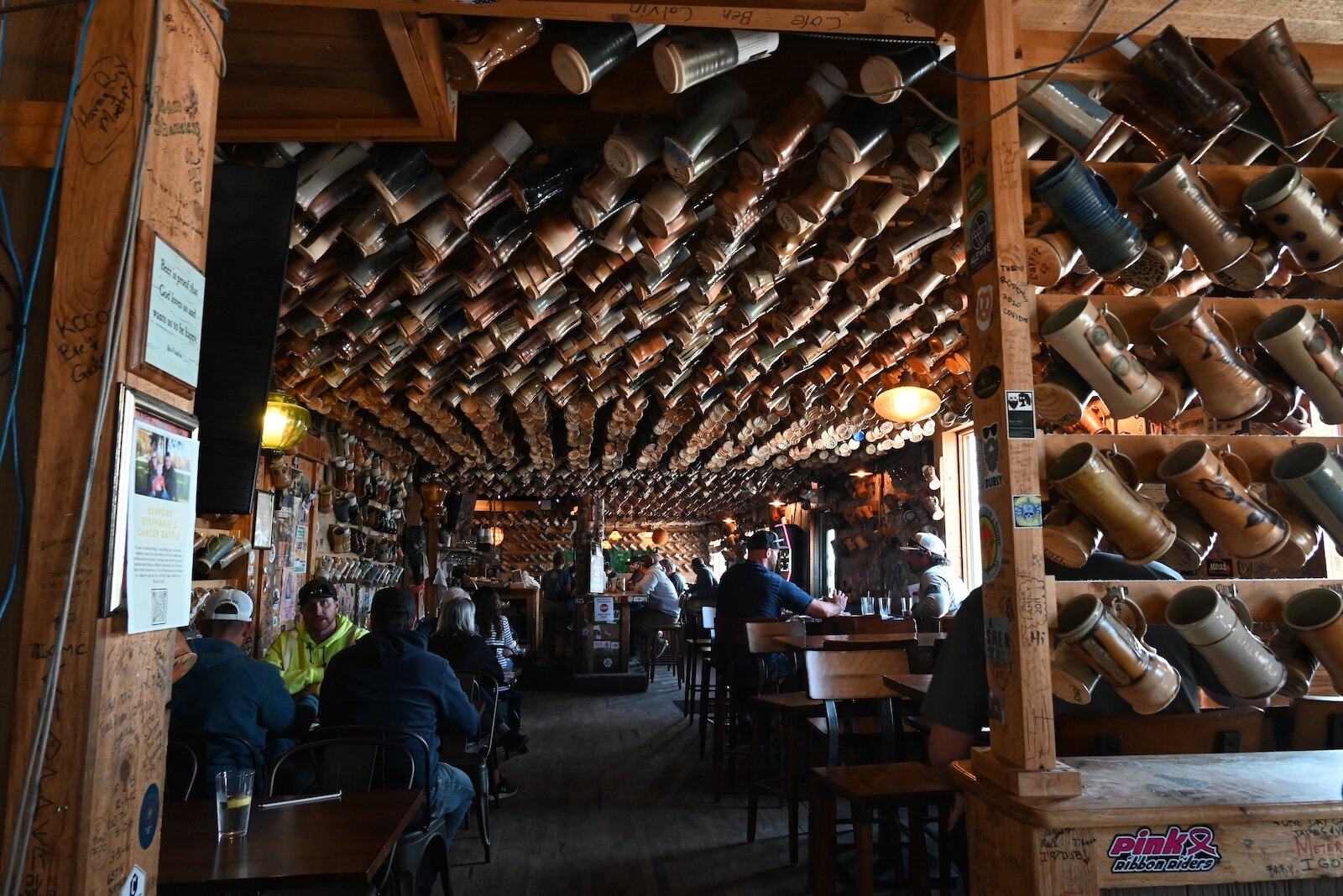 Scenes inside Dark Horse’s tap room feature some of the hundreds of mugs.